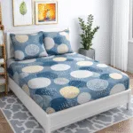 Blue woollen bedsheet with modern circular patterns in beige, ivory, and grey, laid flat to show its soft texture and warm, cozy fabric suitable for winter use.